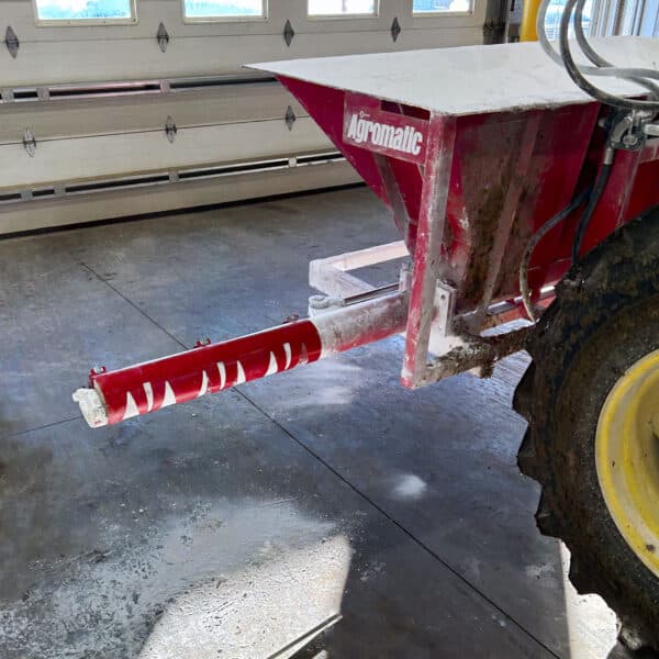 AG Lime Spreader dispensing unit hydraulic arm on a tractor.