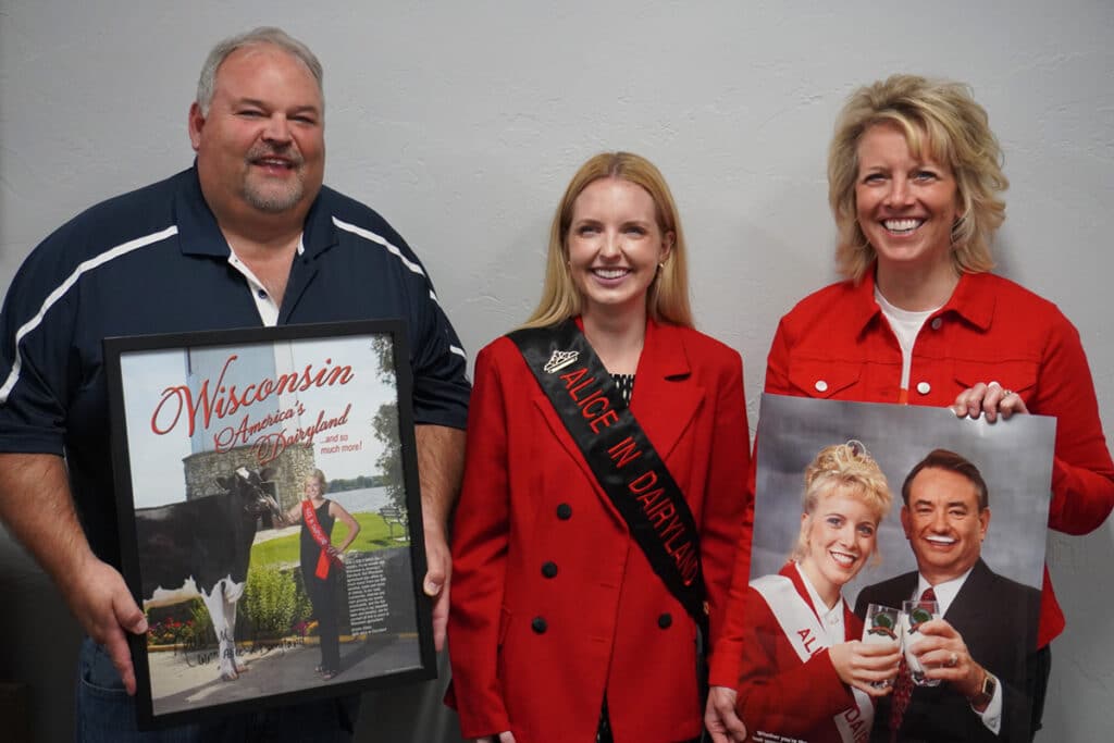 Dean Birschbach, Ashley Hagenow and Courtney Booth at Agromatic holding Alice in Dairyland legacy pictures.