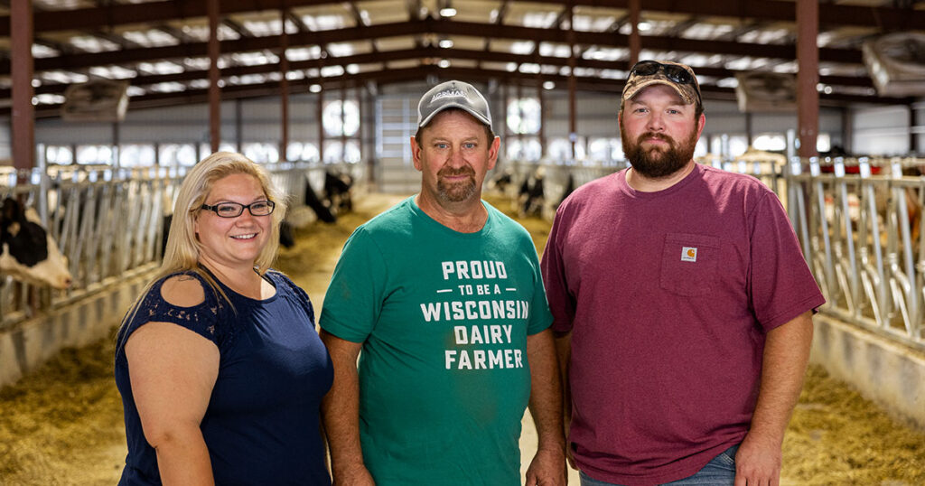 Virhada Holsteins, LLC Mt. Horeb, WI - Virgil Haag and family inside cow barn.