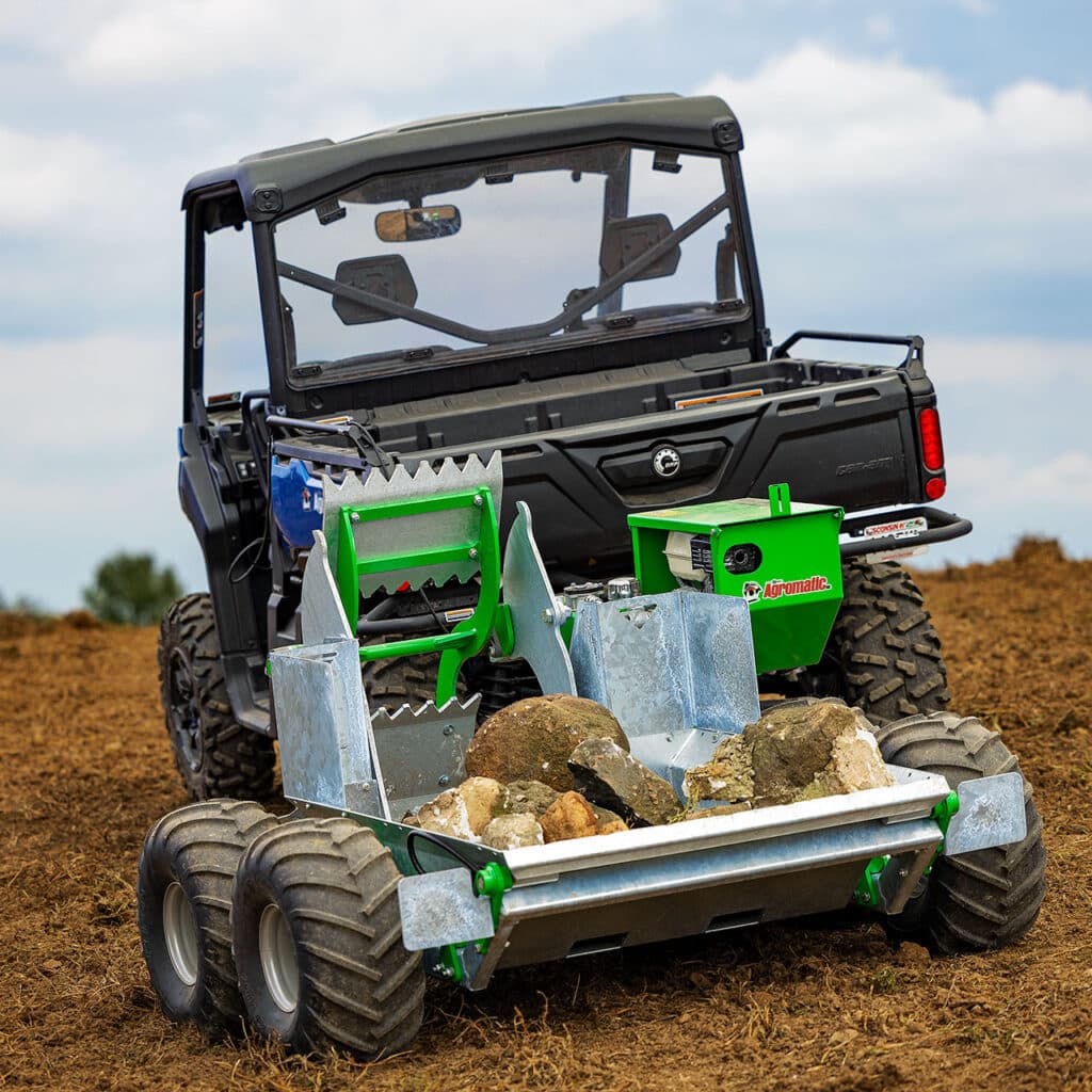 The Stoneless ATV Rock Picker in a farm field loaded with tocks.