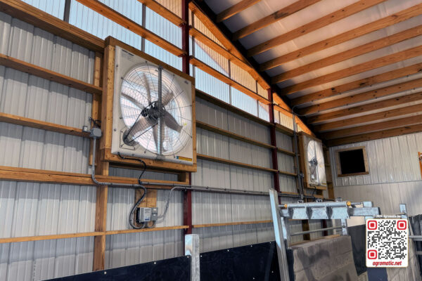 Electrical installation of positive pressure fans in cow barn (inside view).
