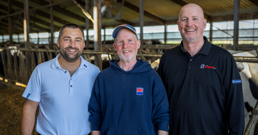 J&M Hofacker dairy farm in Appleton, Wisconsin with Joscha Sadowski, John Hofacker, and Erik Niemeier celebrating 20 year old dairy barn flooring.