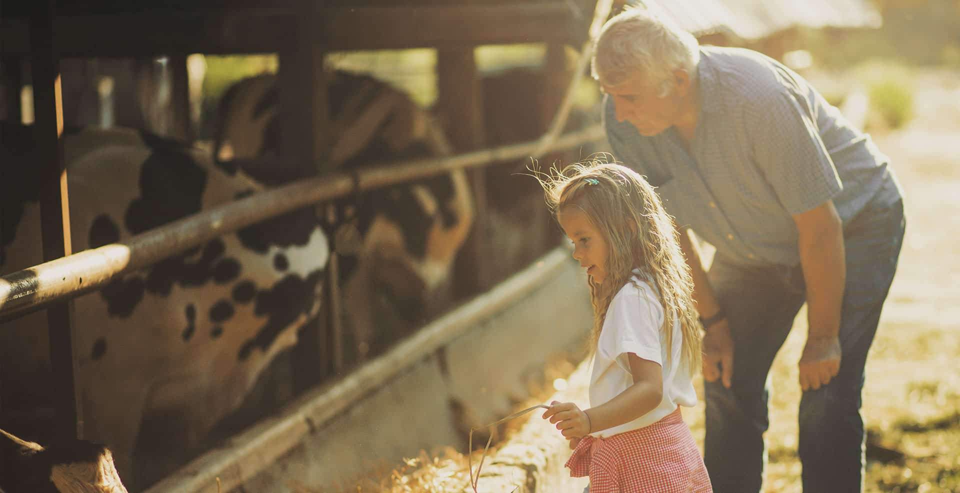 June Dairy Month picture of kid drinking milk in a glass outside.